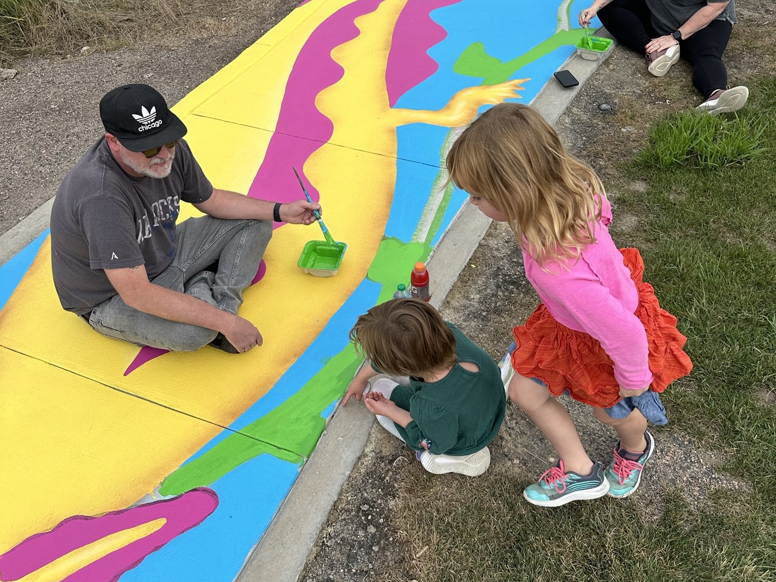 a man and children painting on Adams County trail